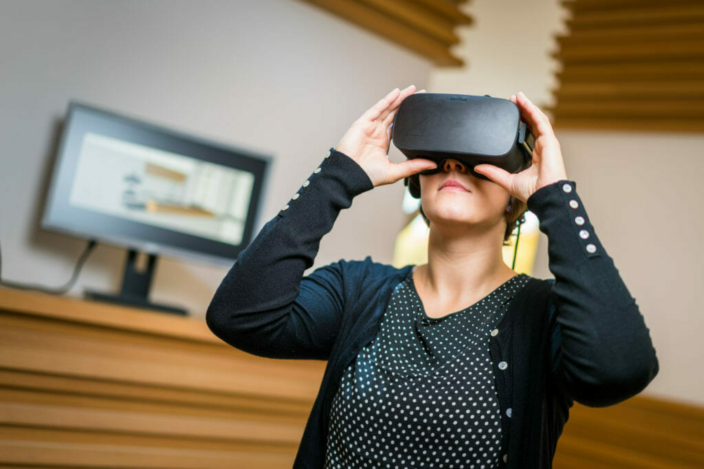 eine Frau betrachtet Ihre zukünftige Einrichtung mit einer VR-Brille